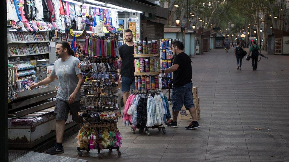 Men opening up a shop on Las Ramblas