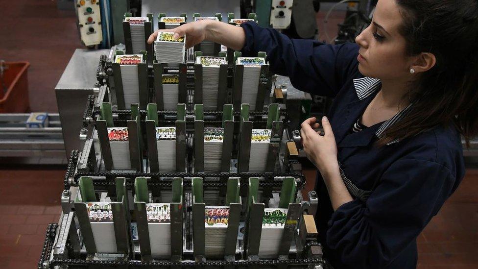 A worker prepares packages of stickers at the Panini Group factory in Modena, northern Italy, ahead of the 2018 World Cup in Russia