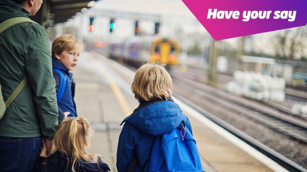 family waiting for train on platform