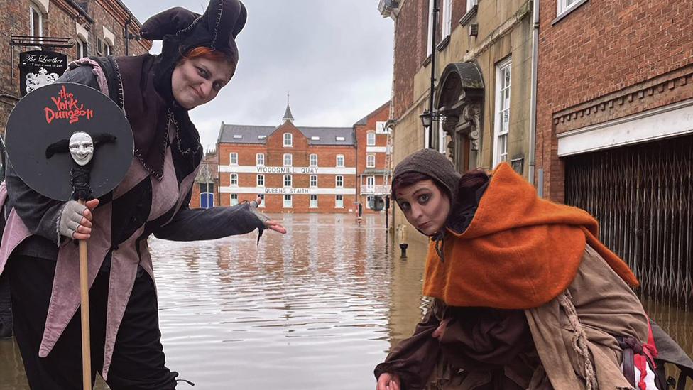 Jester in front of flood water