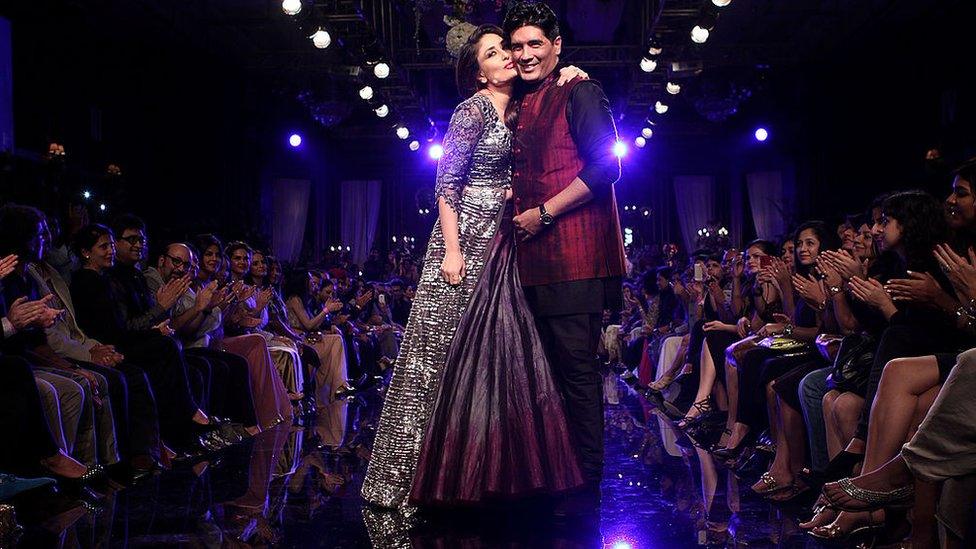 Kareena Kapoor (L) walks the ramp with Manish Malhotra (R) during day 5 of Lakme Fashion Week Winter/Festive 2014 at The Palladium Hotel on August 24, 2014 in Mumbai, India.