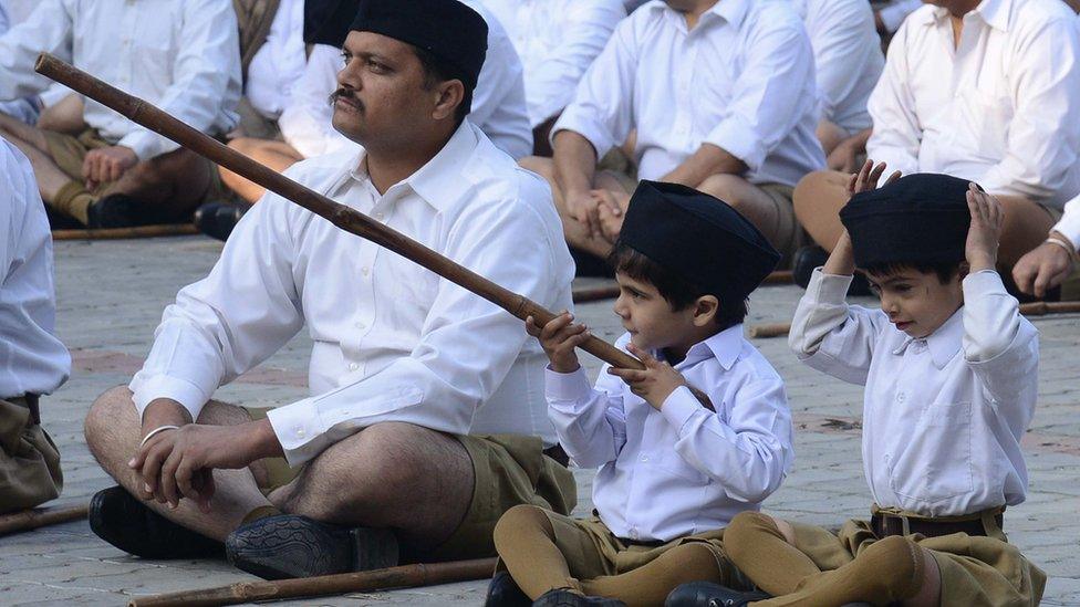 Indian volunteers of the Hindu nationalist Rashtriya Swayamsevak Sangh (RSS) listen to speeches before marching to mark the foundation day of the RSS, in Amritsar on November 10, 2013.