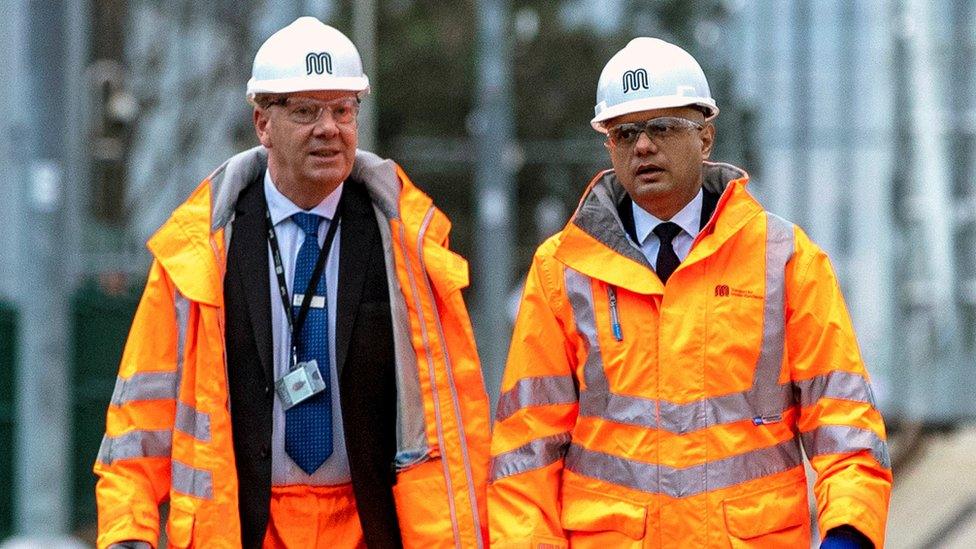 Sajid Javid, right, visiting Trafford Park Metrolink tram