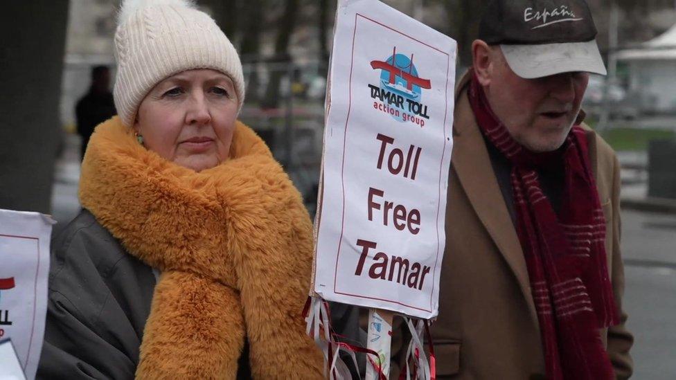 Protestors holding a sign saying 'Toll Free Tamar'