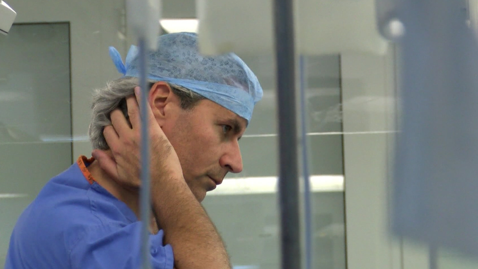 Prof Karim Brohi in scrubs