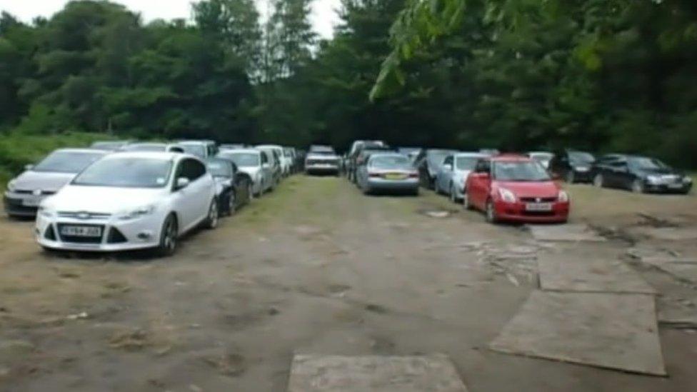 Trading Standards footage of cars parked in a field