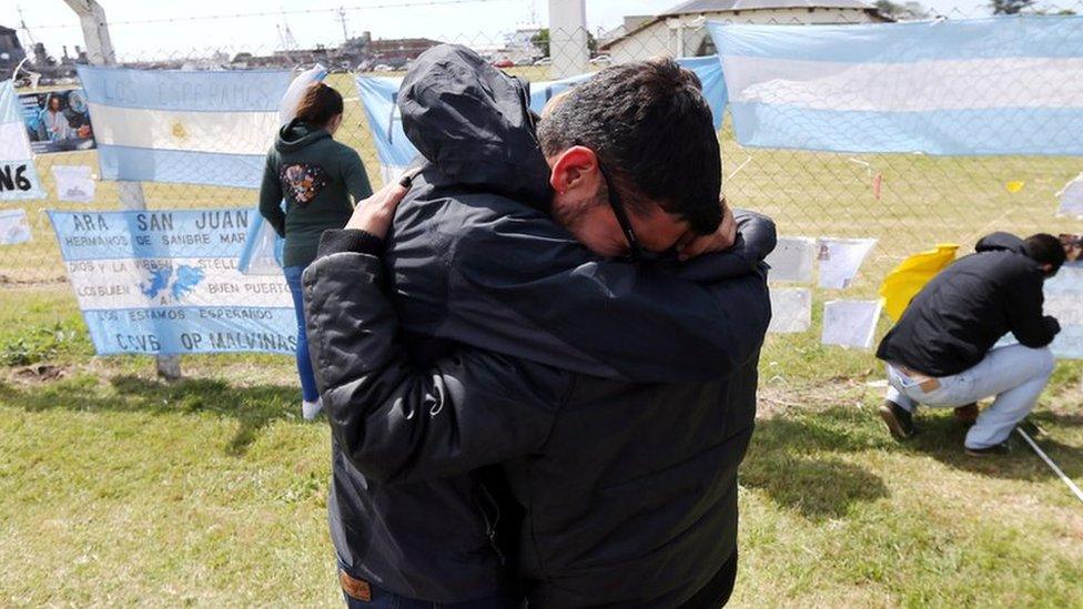 Relatives of a missing crew member hug outside the naval base in Mar del Plata (24 Nov)