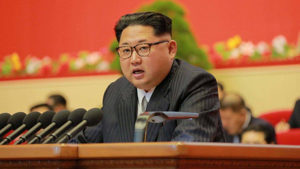 Kim Jong Un speaking from a lecturn