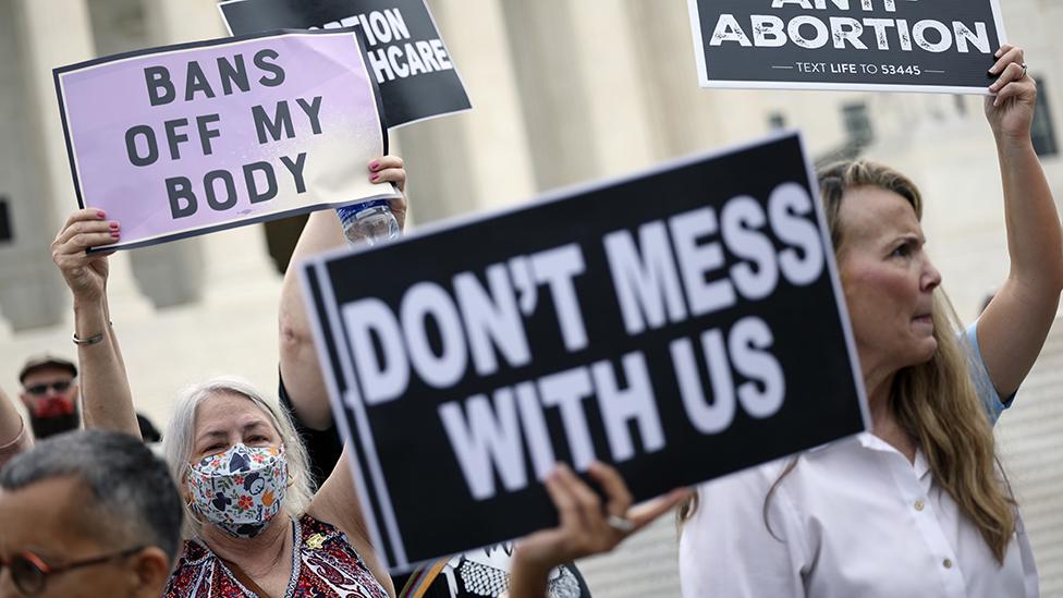 Pro-choice and anti-abortion activists protest alongside each other during a demonstration outside of the Supreme Court on October 04, 2021 in Washington, DC.