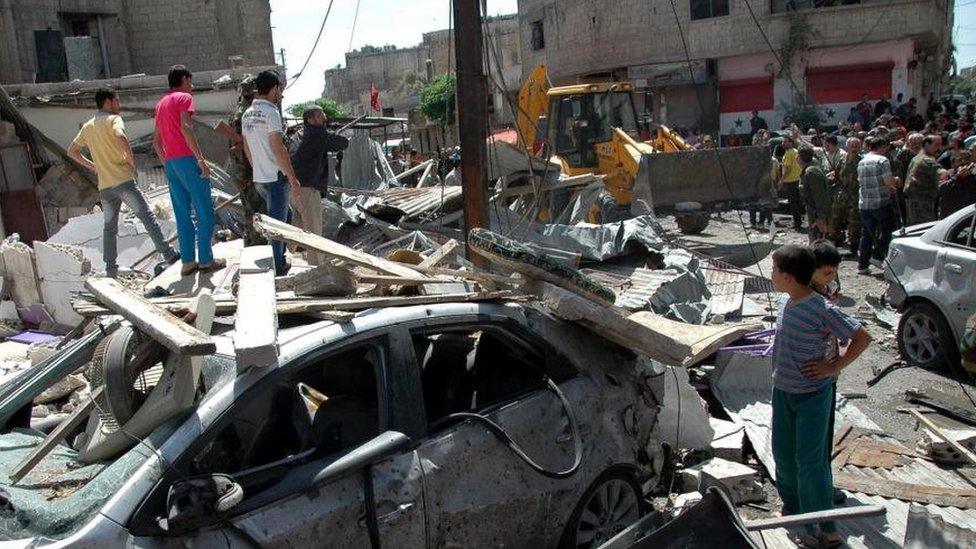 Aftermath of a car bombing in the Abbasiya district of Homs (29 April 2014)