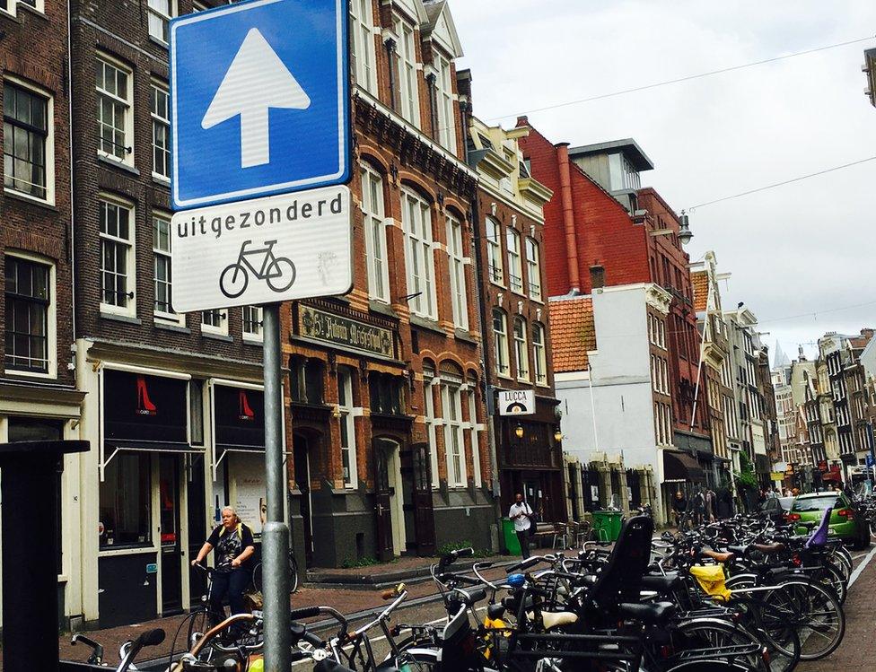 Dutch street sign says one-way except for bicycles