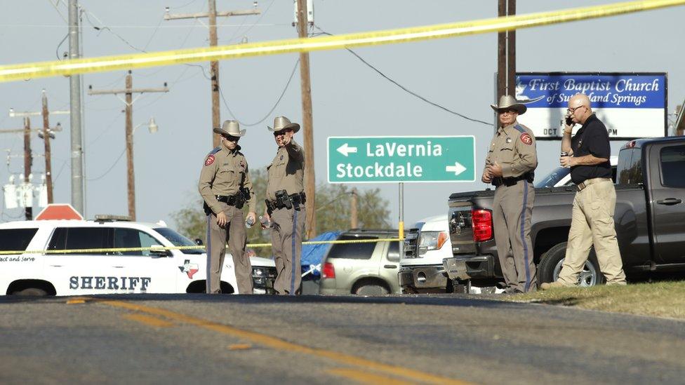 Law enforcement officials gather near First Baptist Church