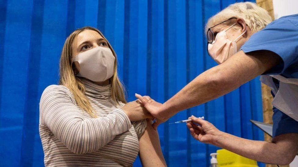 Woman receiving vaccine