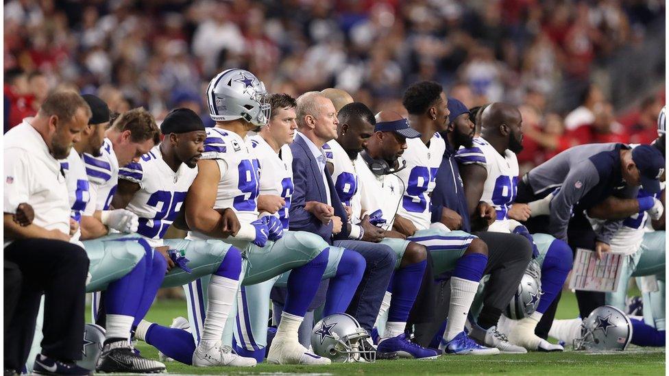 Photo of Dallas Cowboys kneeling before game against Arizona Cardinals