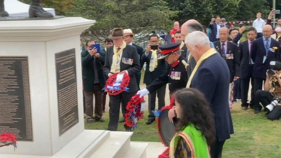 Wreaths are laid at the foot of the Gurkha memorial statue