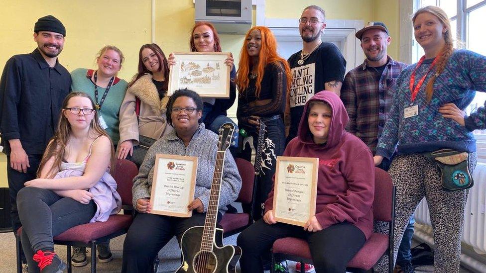 The care leavers holding the award they won