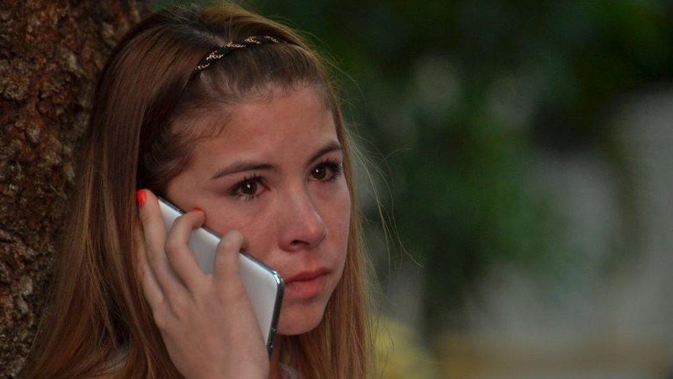 A woman cries as she speaks on her mobile phone after knowing the results of a referendum on whether to ratify a historic peace accord to end a 52-year war between the state and the communist FARC rebels, in Cali, Colombia, on October 2, 2016.