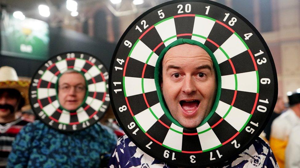 Man with dartboard around face