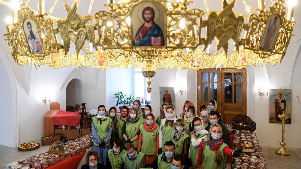 Orthodox volunteers attend the blessing of traditional cakes and eggs to be distributed to people in need, on the eve of the Orthodox Easter in Moscow on April 18, 2020