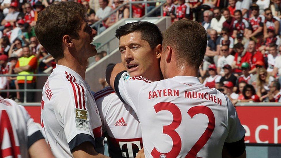 Robert Lewandowski (centre) celebrates scoring a penalty for Bayern Munich against Ingolstadt with team-mates Thomas Muller (left) and Joshua Kimmich