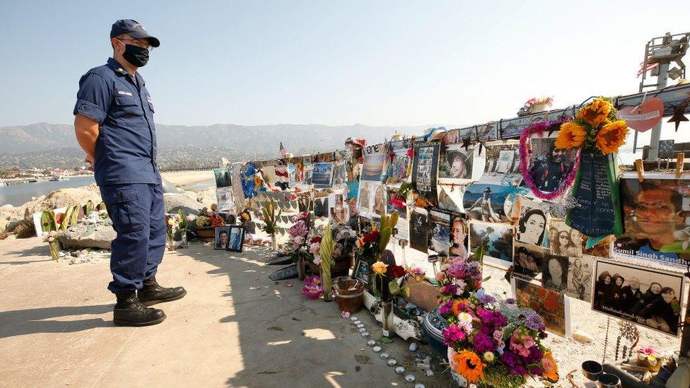 US Coast Guard Lt Commander Joe Price-Larson with fellow Coast Guard members visit a memorial for the 34 people who died in the Conception Boat fire