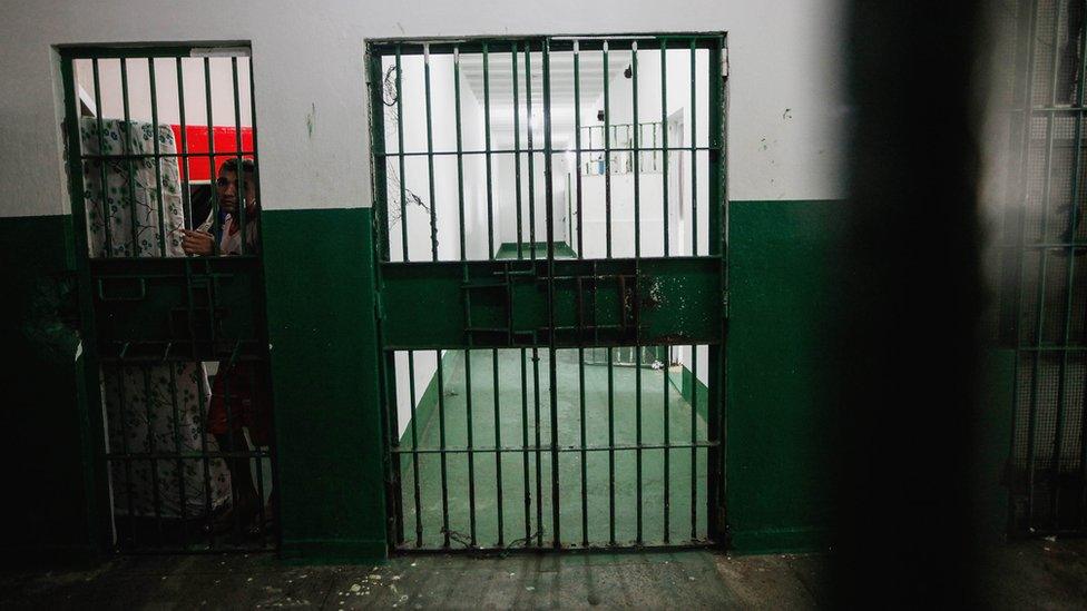 An inmate stands in the Anisio Jobim penitentiary complex on February 17, 2016 in Manaus, Brazil.