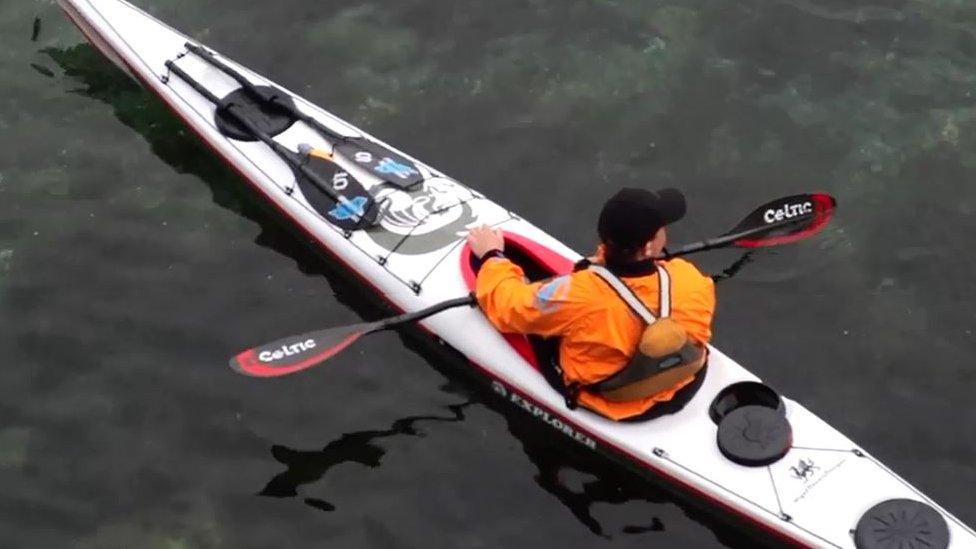 Shot of Kim Tastagh in his kayak from above