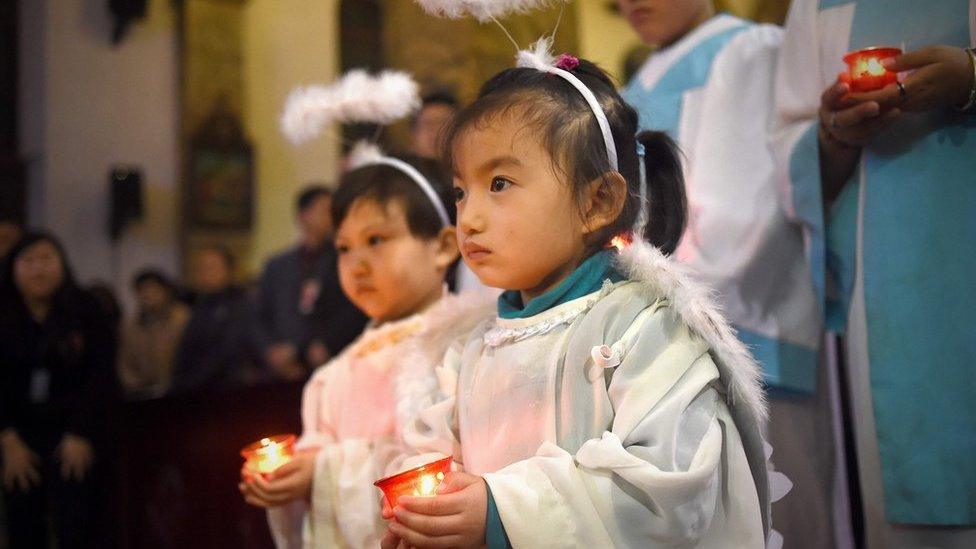 Young Chinese worshippers attend the Christmas Eve mass at a Catholic church in Beijing on December 24, 2015