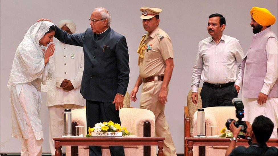 : Punjab governor Banwarilal Purohit blesses Cabinet minister Anmol Gagan Mann after the oath ceremony as a Minister in Punjab government at Punjab Raj Bhawan on July 4, 2022 in Chandigarh, India.