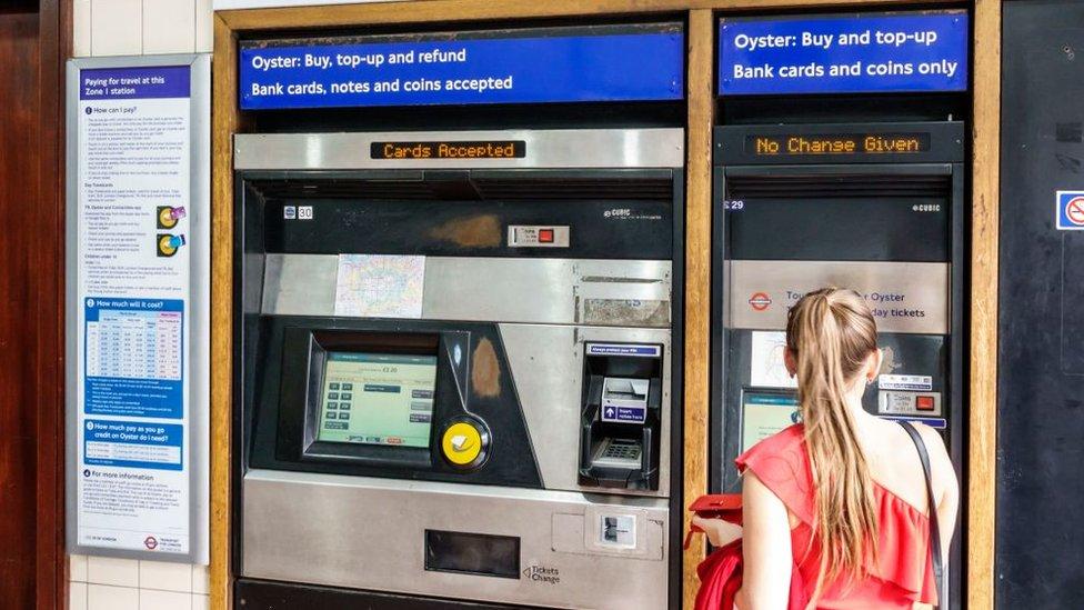 A passenger buying a ticket at a machine