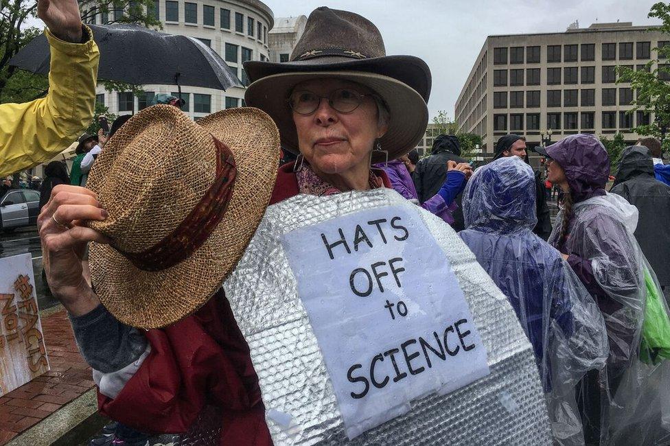 Woman with sign reading Hats Off To Science