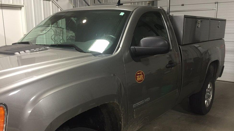 A grey truck in excellent condition, bearing the logo of Zelnio Construction.