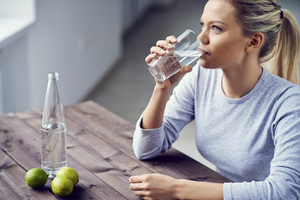 Young woman drinking water