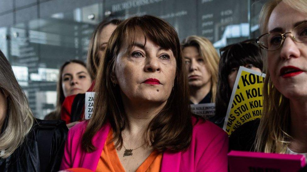 Polish activist Justyna Wydrzynska (C) speaks to journalists at the district court in Warsaw as she came for the next hearing in her case where she is accused of giving abortion assistance, on March 14, 2023