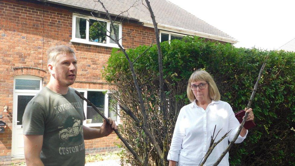 Lloyd Stacey and Sue Nickels with fallen branch