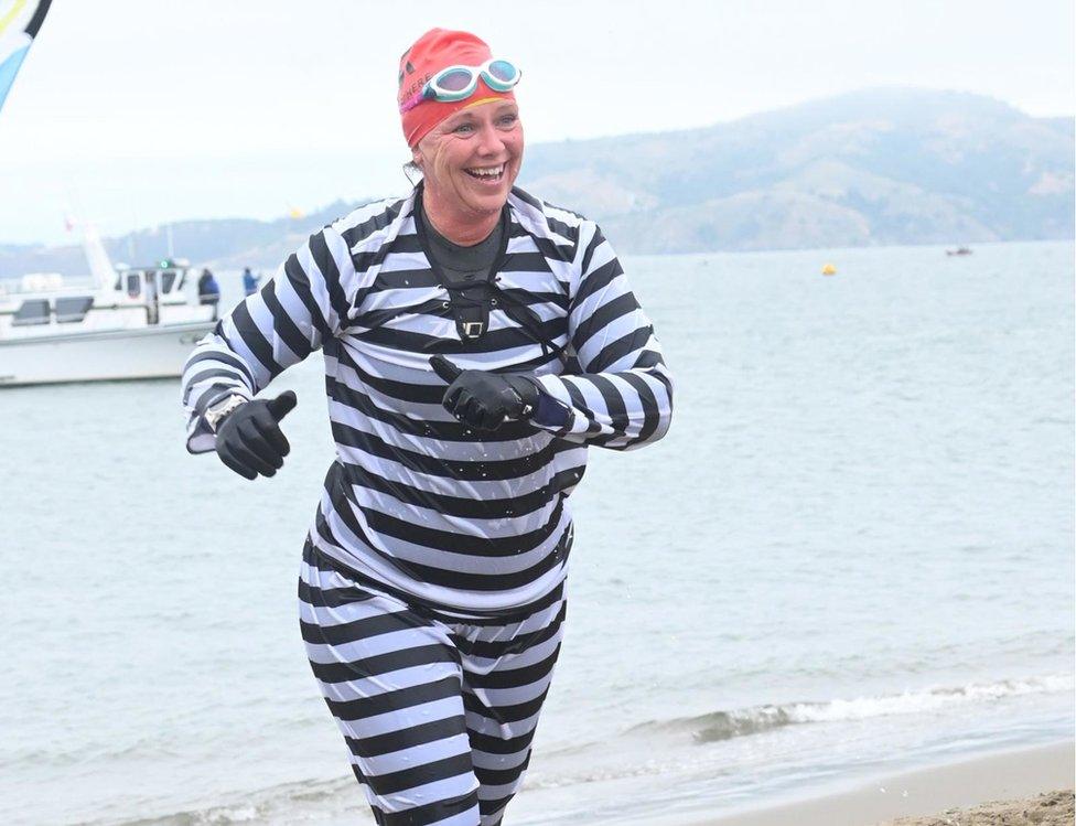 Sally Orange running in convict outfit