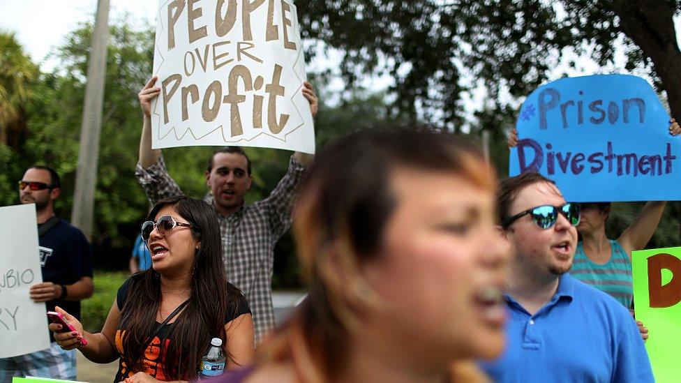 Protesters gather in front of the GEO Group headquarters to speak out against the company that manages private prisons across the United States on May 4, 2015 in Boca Raton, Florida.