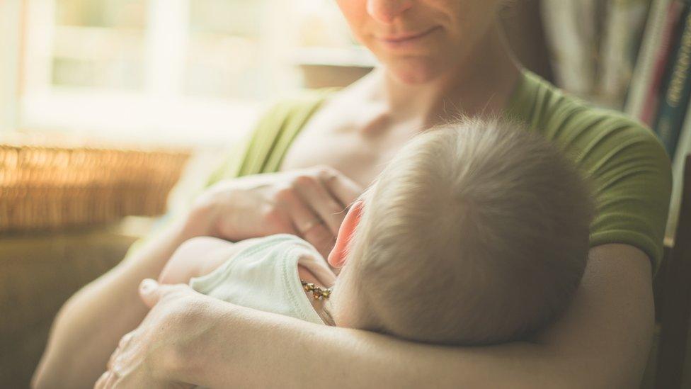 Mother breastfeeding baby