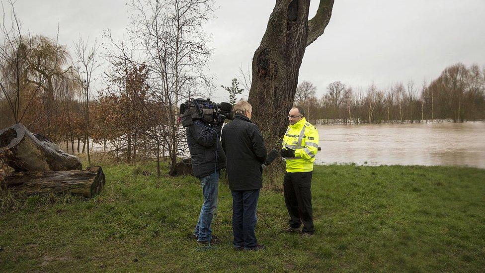 Dave Throup, Environment Agency Manager for Herefordshire and Worcestershire, speaks to television journalists near Waterworks Road on February 12, 2014 in Worcester, England