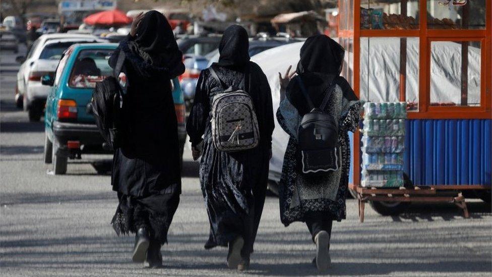 Afghan female students walk near Kabul University in Kabul, Afghanistan, December 21, 2022