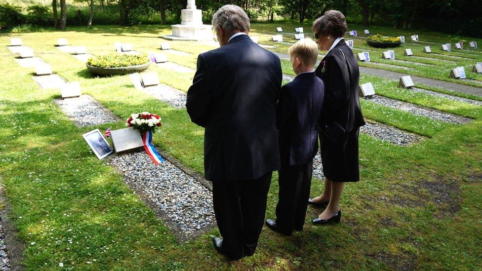 Mary and Julian Cox and their grandson Teddy pay their respects