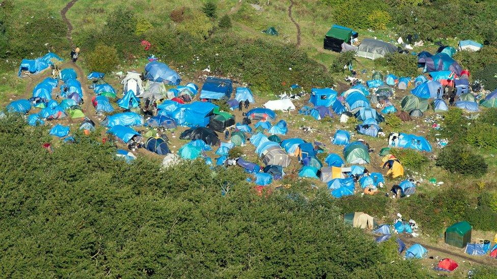 Blue tarpaulins cover many of the shelters, structures and tents to protect against the elements as winter approaches.