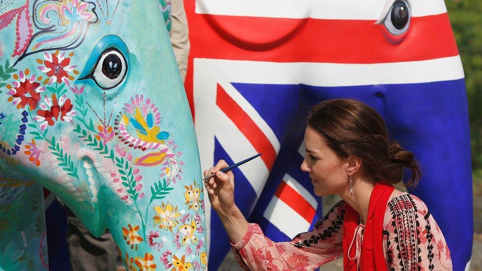 The Duchess of Cambridge decorates an elephant parade statue at the discovery park in Kaziranga