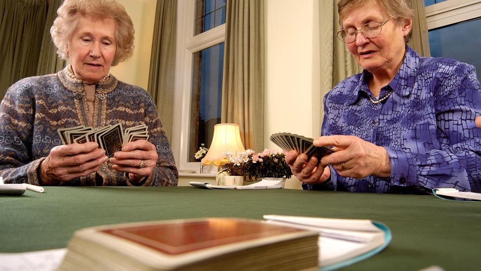 Two ladies playing bridge