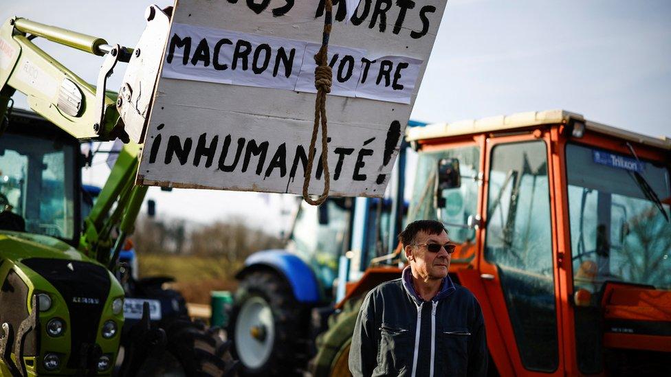 Eric Hardy, 62, grain farmer from Eure-et-Loir, looks on as French farmers block a highway