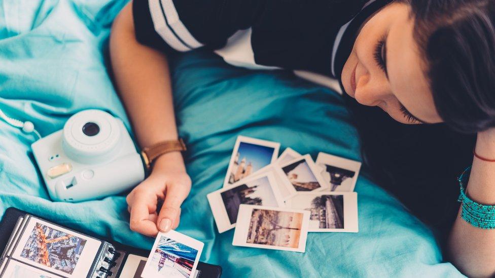 Woman looking at photographs