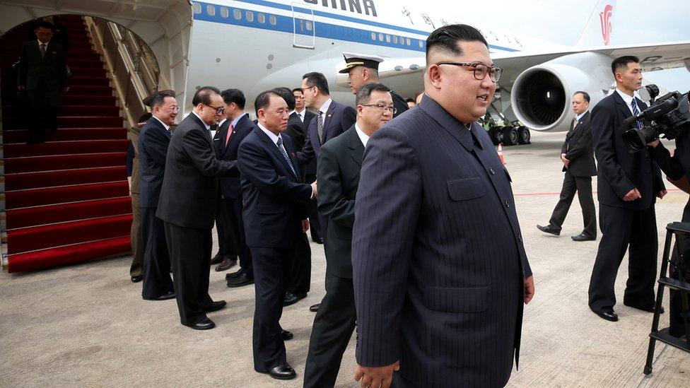 Kim Jong-un walking off his plane in Singapore