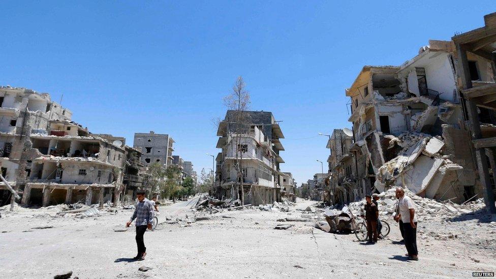 People inspect a site hit by what activists said were barrel bombs dropped by forces loyal to Syria"s President Bashar al-Assad in Aleppo"s eastern district of Tariq al-Bab June 25, 2014.