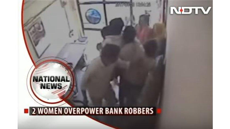 CCTV footage showing several people detain two bank robbers in