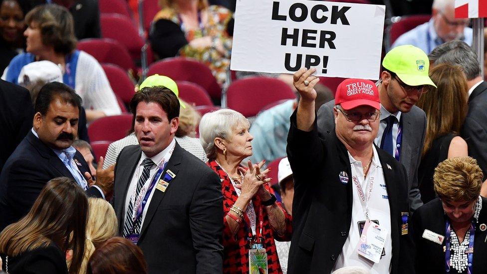 Man holding Lock Her Up sign